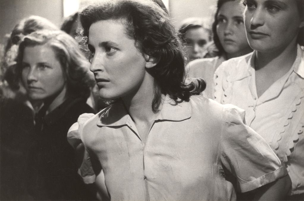 Vintage black and white photo showing young women looking serious.